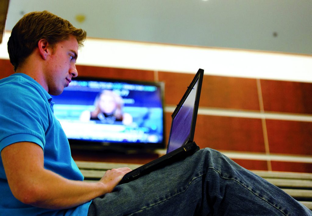 Student sitting with laptop.